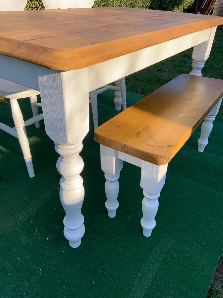 white dining room table and bench with stained wooden top