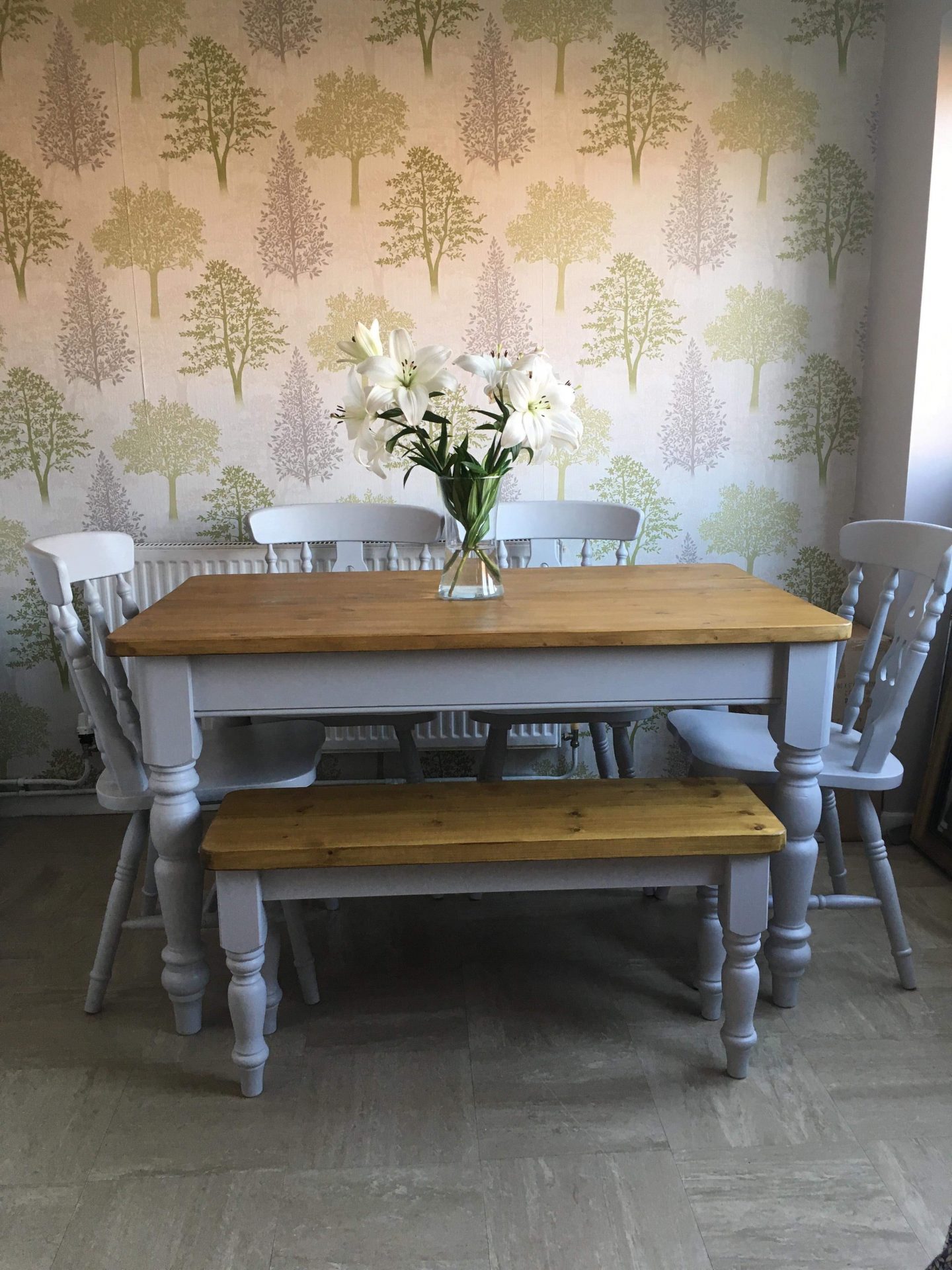 Small grey dining table made from reclaimed wood with bench