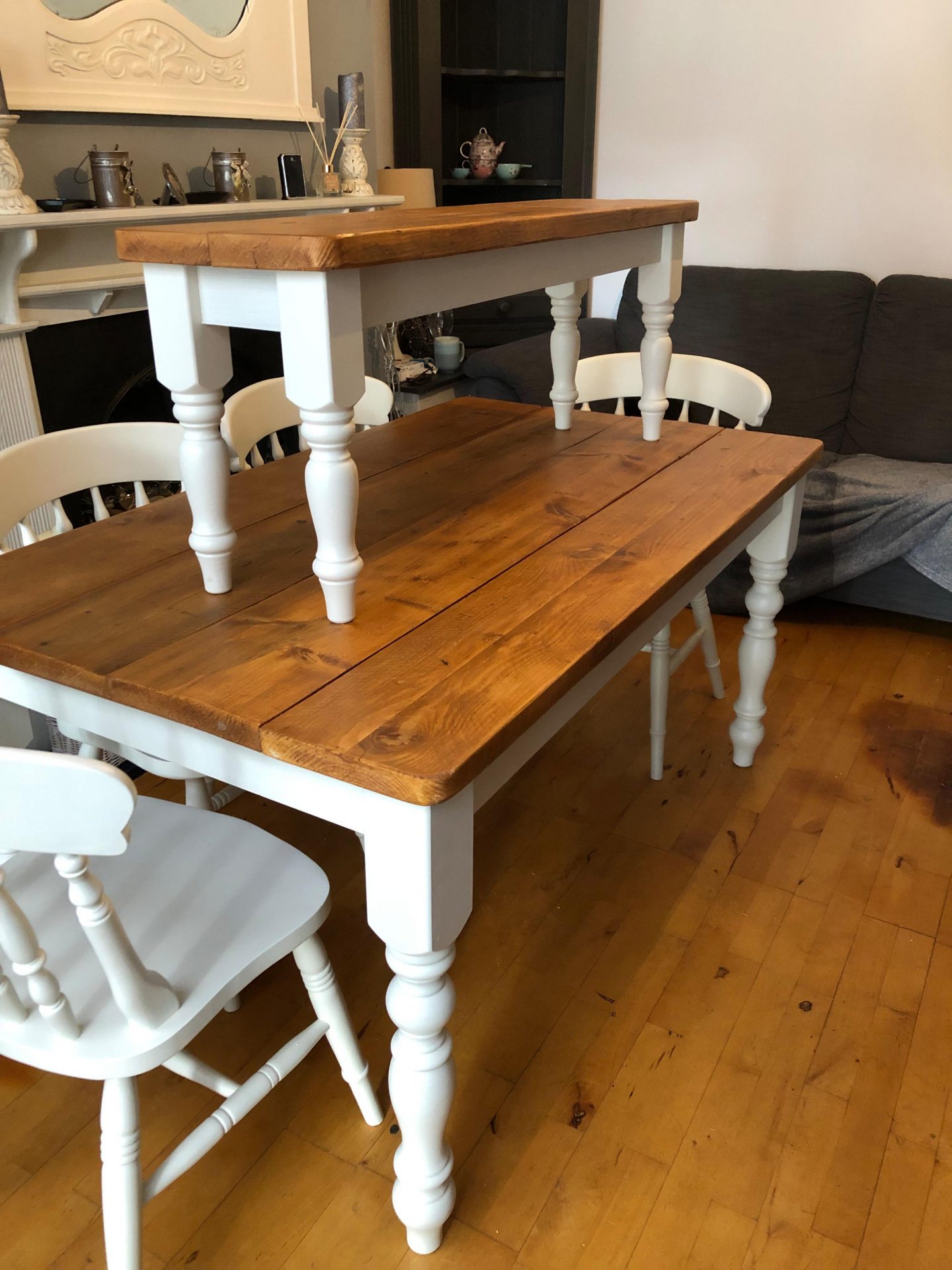 Dining room table with white painted legs and reclaimed wood table top